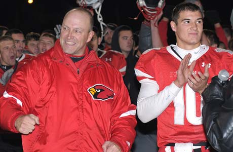 Mentor head coach Steve Trivisonno celebrates with his players following the victory.