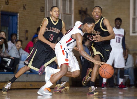 Hallice Cook and Tarin Smith of top-ranked St. Anthony pressure an opposing ballhandler during a game in February. The Friars are allowing just 33 points per game in postseason play.