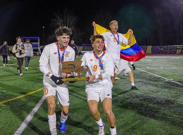 Newton North players celebrate their Massachusetts Division 1 title after beating St. John's 2-1. (Photo: Brian Kelly)