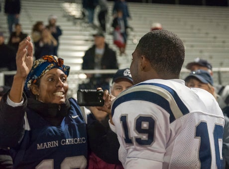The moment of truth: Akili Terry takes family pictures following regional championship win over Sutter in Oroville.
