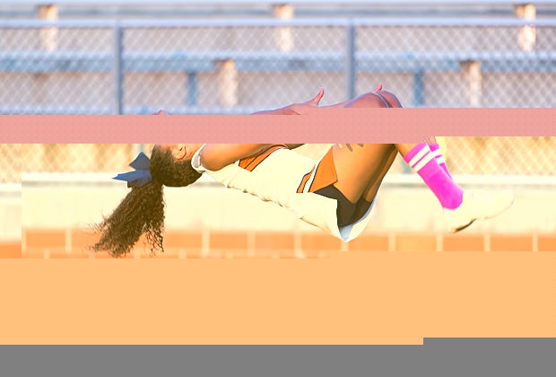 A Madison (San Antonio) cheerleader does a somersault on the sidelines.