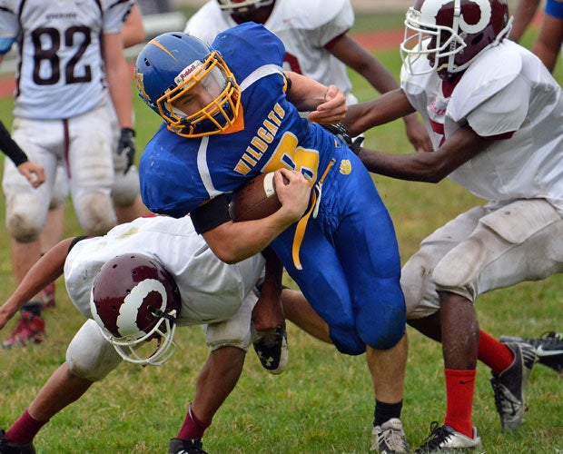 A Maple Shade (N.Y.) junior varsity player splits two Riverside defenders.