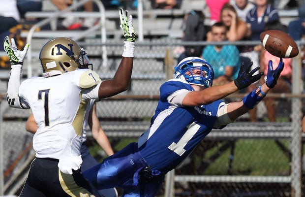 Hall (Conn.) receiver Neil Kelley attempts to make a diving catch in front of Newington cornerback Mathias Smith.