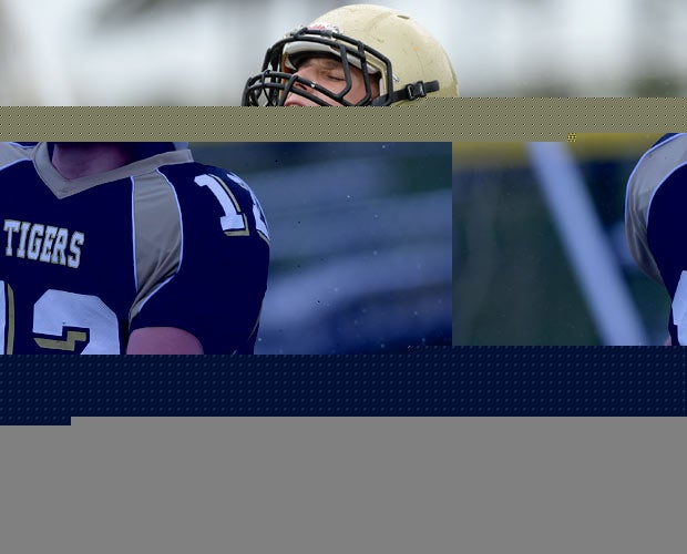 A Hand (Conn.) player celebrates while scoring a touchdown in the rain against North Haven.