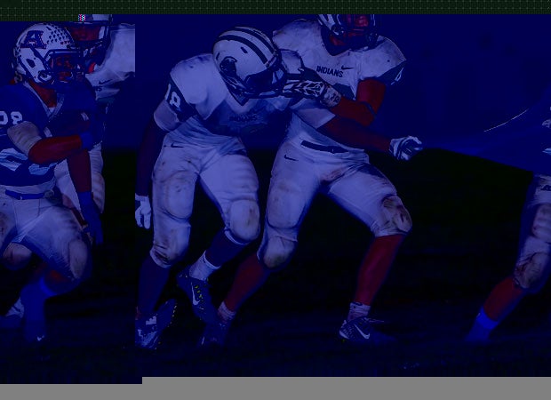 Apponequet Regional (Mass.) running back Matt Michael attempts to elude the grasp of a Dartmouth defender.