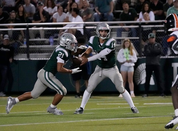 De La Salle quarterback Brayden Knight hands the ball to Duece Jones-Drew in the Spartans' 10-7 win over Florida power Lakeland on Friday in the MaxPreps Game of the Week. (PHOTO: Ernie Abrea)