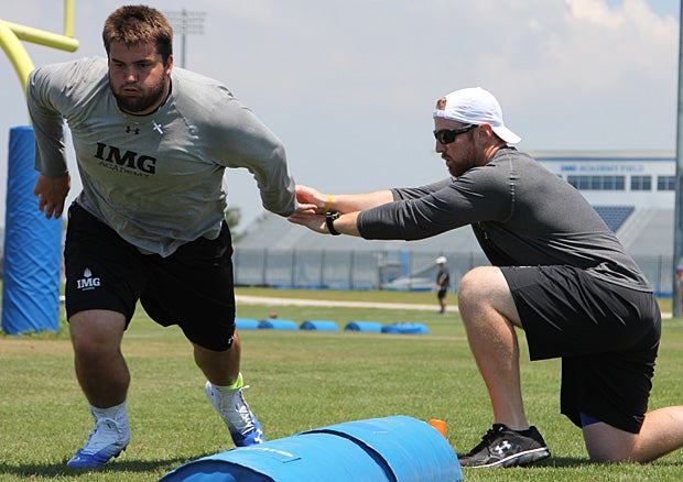 Foster works with offensive line coach Spencer Hodges to sharpen his fundamentals as he preps for Syracuse.