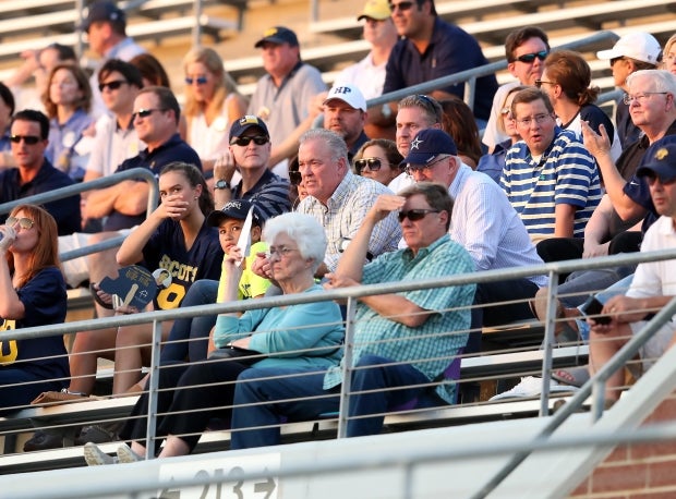 Stephen (center) and Jerry Jones (in blue Cowboys hat) watch John Stephen Jones lead Highland Park to a win Thursday.