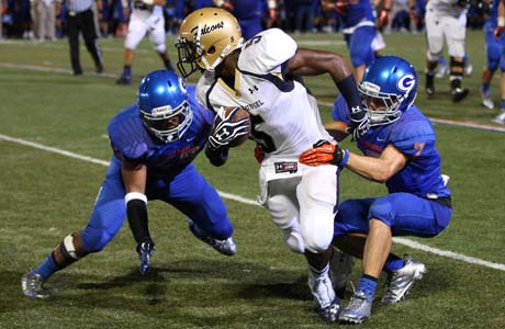 Good Counsel receiver Kendall Fuller attempts to elude two Bishop Gorman defenders.