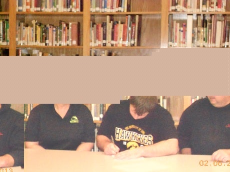 Nathan Bazata inks his National Letter of Intent Wednesday at his school. The Nebraska 8-man player will head to the University of Iowa.