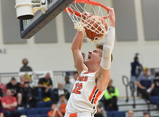 Versailles junior and Ohio State commit Justin Ahrens slams home two of his game-high 26 points in a win over Tri-Village.