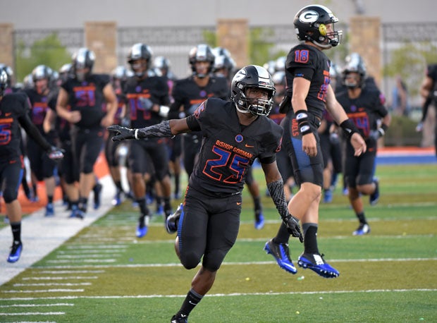 Tyjon Lindsey (left) and a leaping Tate Martell are pumped during pregame introductions before a 2015 game.