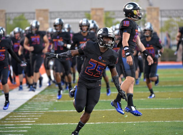 Tyjon Lindsey (left) and a leaping Tate Martell are pumped during pregame introductions before a 2015 game. 