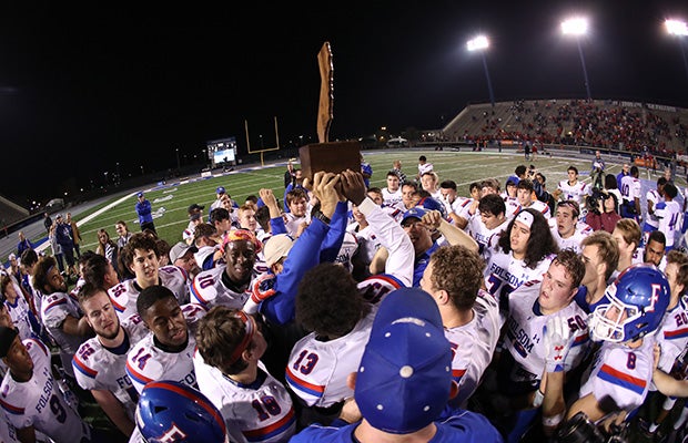 Folsom coaches and players hoist the championship trophy following their thrilling victory in overtime.