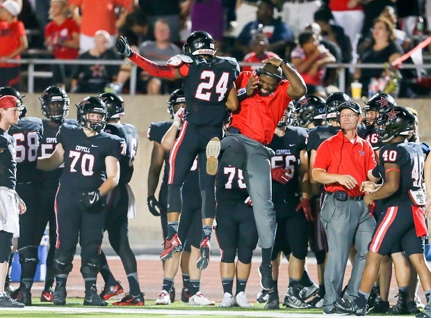 No. 24 Gabriel Lemons celebrates with a Coppell coach.