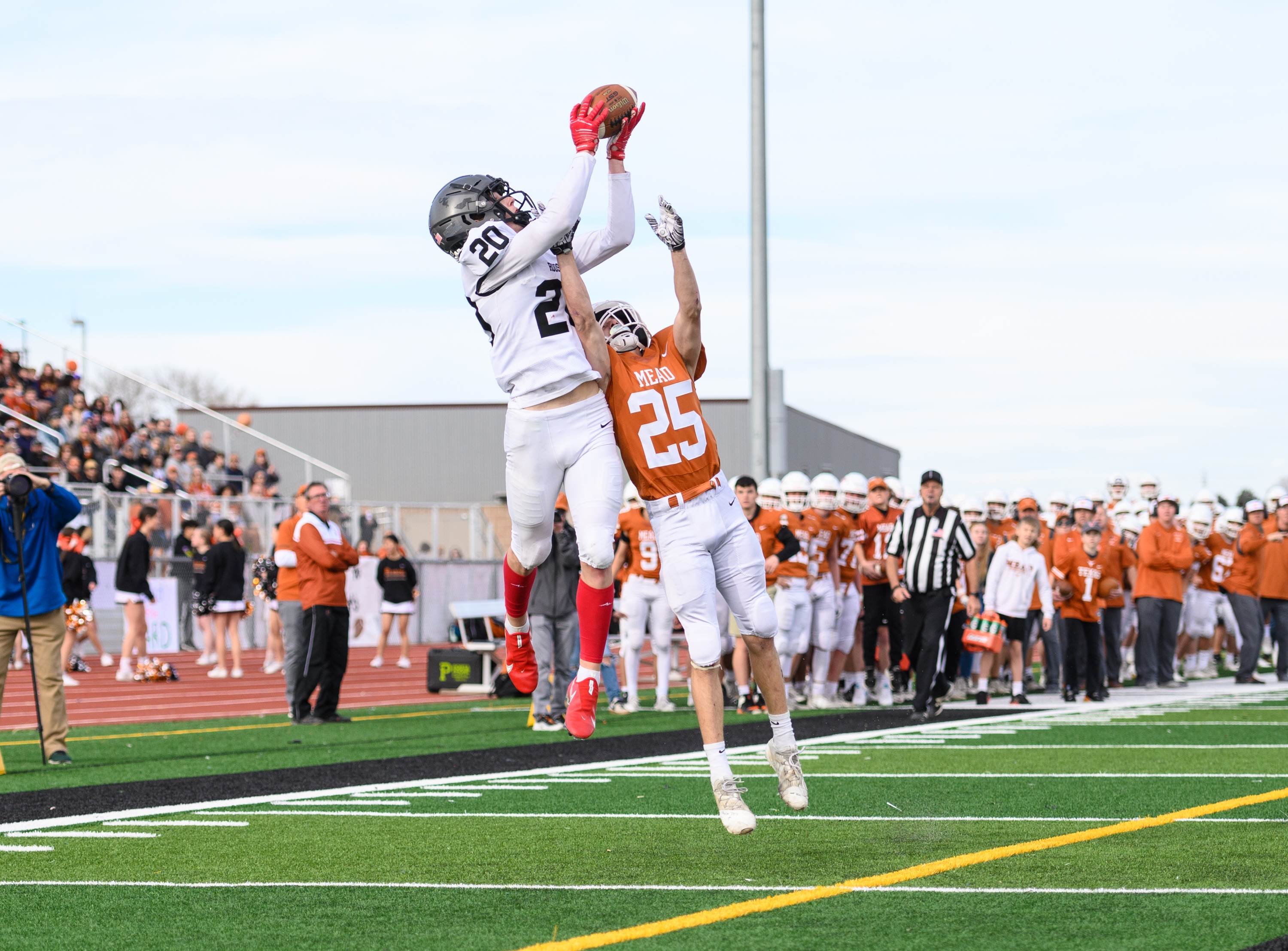 Roosevelt wide receiver Tucker Peterson makes a leaping catch over Mead cornerback Lane Beumer in the endzone to score a Rough Riders touchdown.