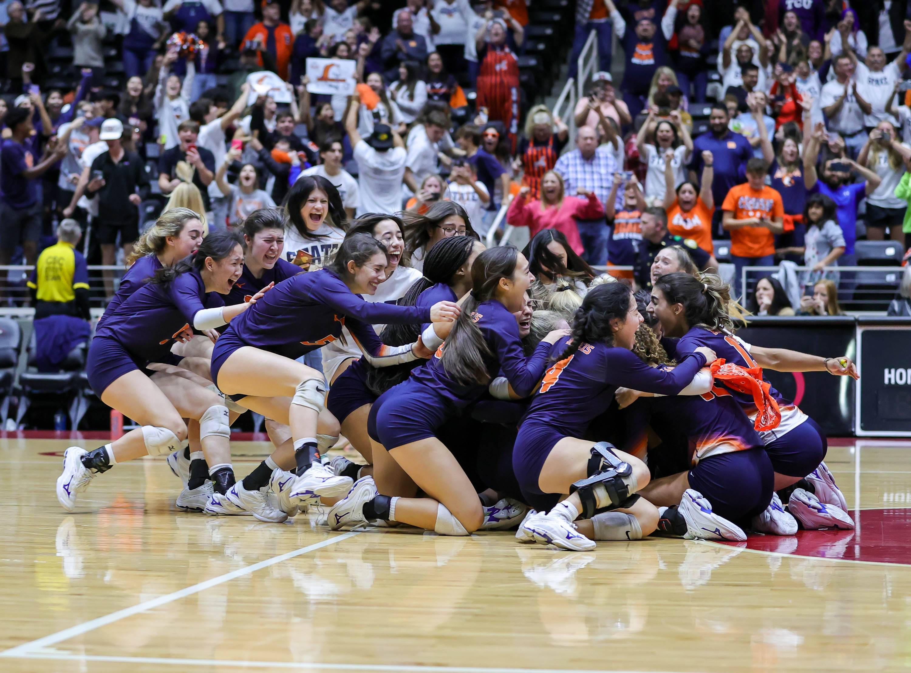 Brandeis volleyball players celebrate after winning the Texas UIL 6A State Final match against Keller.