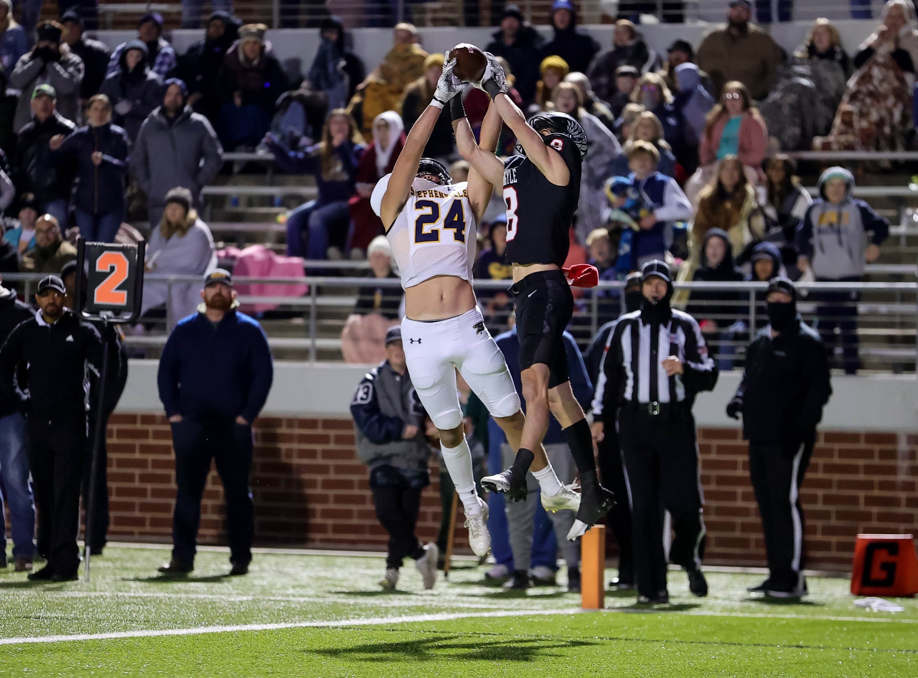 Stephenville's Reece Elston and Argyle's Dan Moore battle for the catch in Stephenville's big win over State Champion Argyle in the UIL 4A Division 1 Region Semifinals.