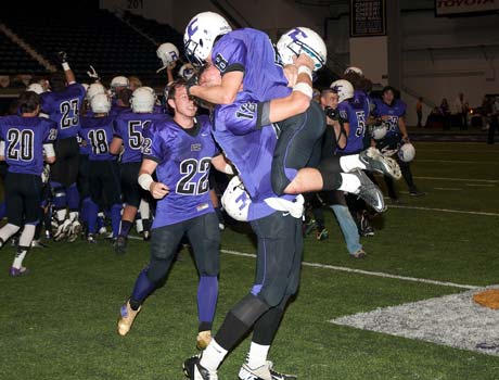 Northwest Christian players celebrate following their victory in the Division 5 championship game on Friday.