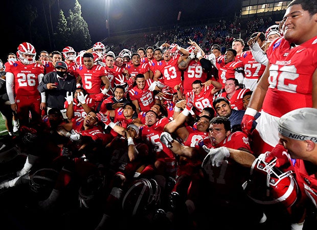 Mater Dei players celebrate their season-ending victory over St. John Bosco on Saturday night.