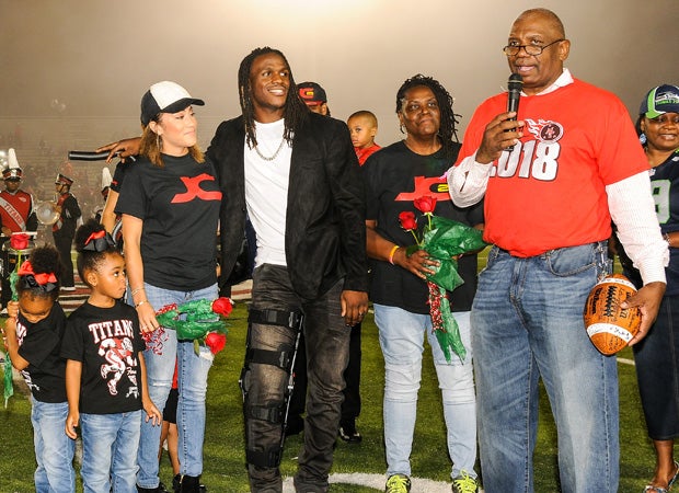 Port Arthur Memorial principal Dr. Glenn Mitchell speaks during the ceremony as Charles and his family look on.