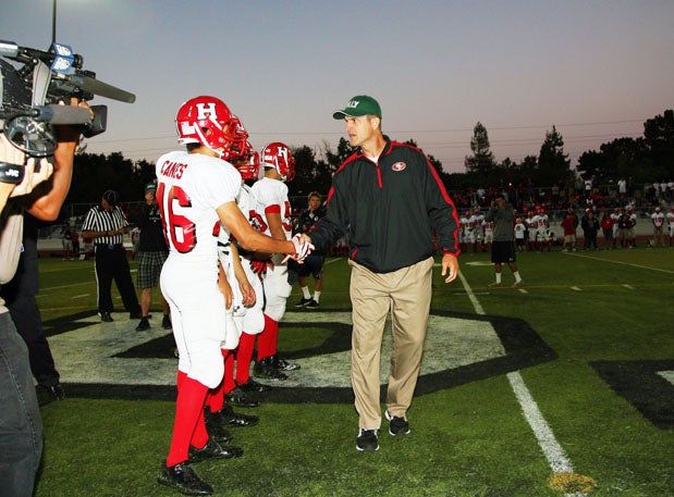 San Francisco 49ers' coach Jim Harbaugh shakes hands with all of the San Benito co-captains, including linebacker John Canes (46). 