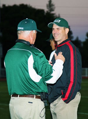49ers' coach Jim Harbaugh enjoys a moment
with his former high school coach and 
current Vikings' head coach Earl Hansen.