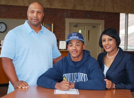 Derrick May Jr., shown with his parents signing his National Letter of Intent to Villanova, never felt pressured to play baseball. But with a father and grandfather who played professional ball, it's no surprise that the Delaware star aims for the big leagues.