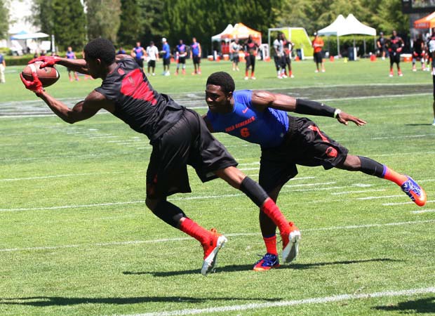 Receiver K.D. Cannon of Mt. Pleasant (Texas) stretches to grab a touchdown pass in front of safety Trey Marshall of Columbia (Lake City, Fla.) during 7 on pool play.