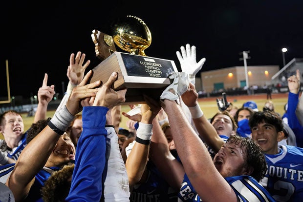 Mesquite holds up the Arizona 4A state championship trophy. 