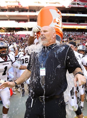 Hamilton coach Steve Belles gets a bath afterwinning the 2012 Division 1 title.