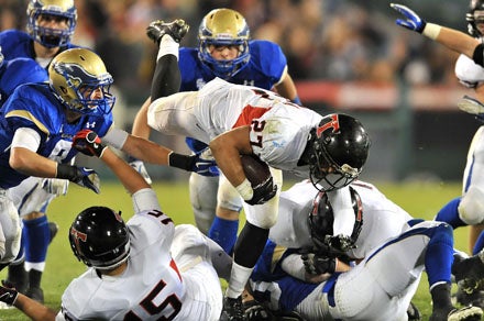 San Clemente's Mike Elespuru (27) gets spun around by the hard-charging Santa Margarita defensive attack.