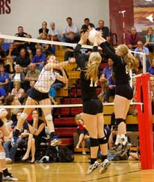 Whitney Kostal (12) and Megan Stroyekof Papillion-LaVista South blockSt. James Academy's Arianna Person.