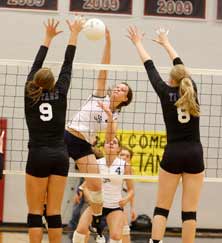 Annie Reilly of St. James Academytries to hit through Katie Kurtz(left) and Megan Stroyek ofPapillion-LaVista South.