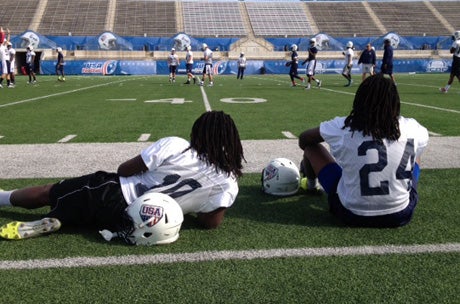 The Griffin brothers, Shaquem (left) and Shaquill enjoy a break during a U-19 practice at Kelly Reeves Athletic Complex in Austin on Sunday.  