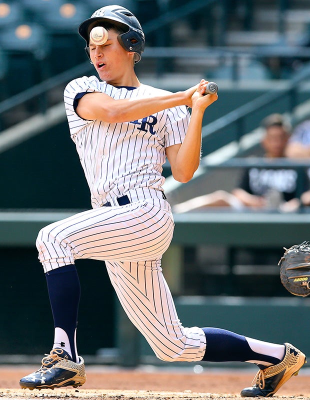 An Ironwood Ridge (Tucson, Ariz.) player fouls a ball off his face during a game at Chase Field in Phoenix.