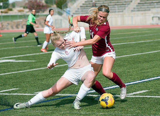 Katie Evans of Chaparral (Parker, Colo.), left, squares off with Hannah Edwards of Cherokee Trail (Aurora, Colo.) for control of the ball.