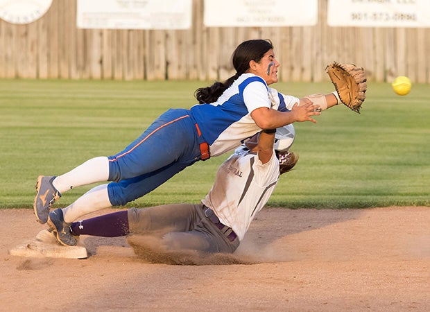 Southaven (Miss.) infielder Joanna Vasquez attempts to catch a throw from the catcher while colliding with a DeSoto Central (Southaven, Miss.) baserunner on a steal.