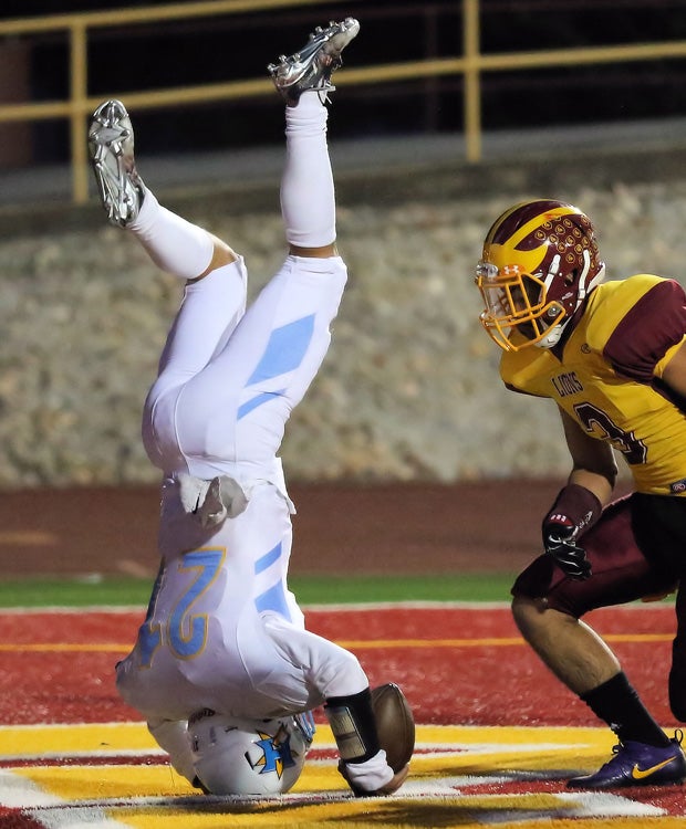 Heritage (Calif.) running back Aidan Quinn does a flip into the end zone after being hit by a Liberty defender at the goal line.