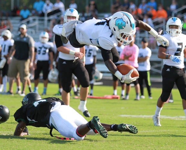 Nature Coast Tech's (Fla.) T.J. Owens leaps over a Weeki Wachee defender for a touchdown.