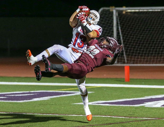 Wall Township (N.J.) receiver R.J. Janeczek outleaps Matawan Regional safety Derrick Wiley for a touchdown catch.