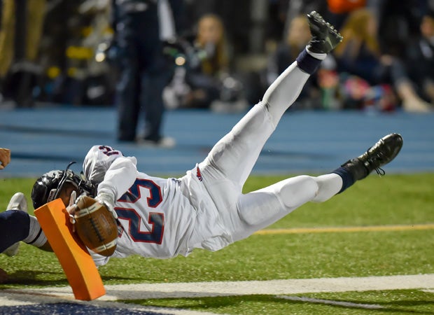 Austintown-Fitch (Ohio) running back Randy Smith leaps while hitting the pylon in the end zone to score a touchdown against McDowell.