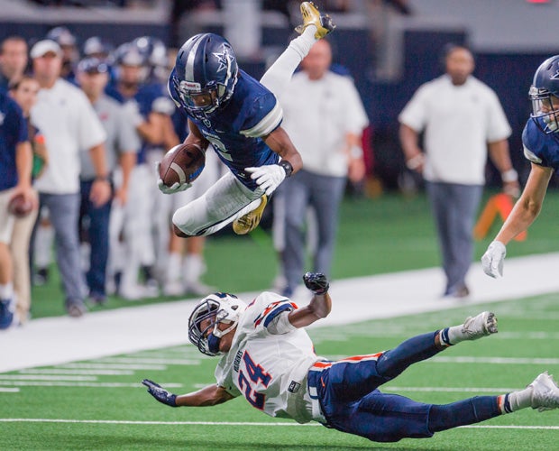 Lone Star's (Texas) Jaylen Dixon soars over Wakeland's Parker Wesley during a game at The Star in Frisco.