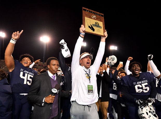 Bosco coach Jason Negro holds Southern Section Division 1 trophy up high. 