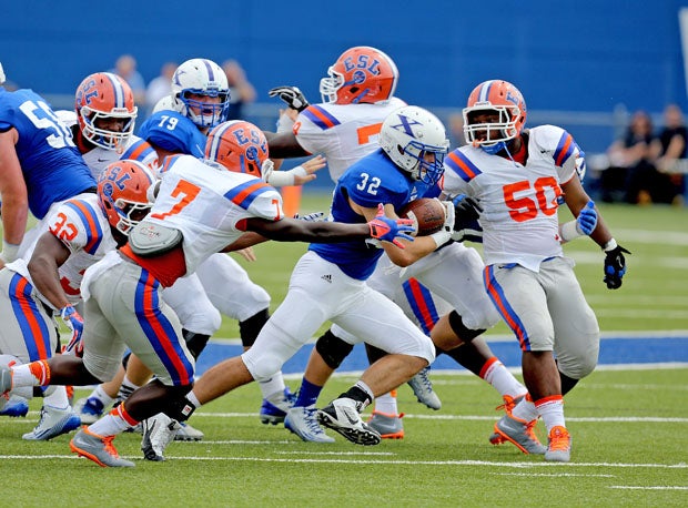 St. Xavier running back Sean Prophit (32) runs behind a big, aggressive offensive line.