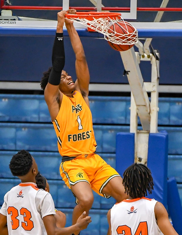 Miles Ray of Pine Forest (N.C.) finishes a dunk against Southern Lee in the Cumberland County Schools Holiday Classic.