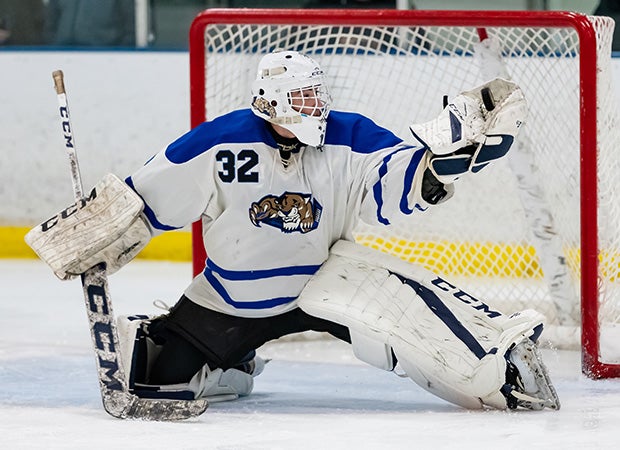 Goalie Francis Gorham of Libertyville (III.) makes a glove save on a slap shot against New Trier.