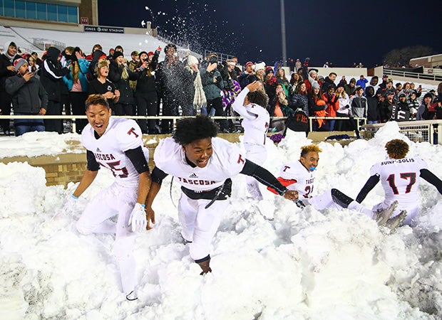 Tascosa (Texas) players celebrate in the snow following their victory over Haltom in a UIL 6A Division 2 quarterfinal game at Jones AT&T Stadium in Lubbock.