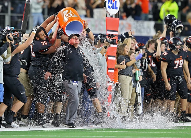 Aledo (Texas) head coach Steve Wood is given an ice bath by his players after winning the UIL 5A Division 2 state championship game at AT&T Stadium in Arlington.