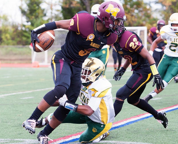Bishop McNamara (Md.) receiver Deonte Hill attempts to elude an Archbishop Carroll defender.